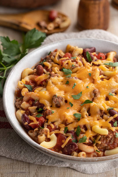 istock Bowl of chili macaroni with cheddar cheese 1278592601