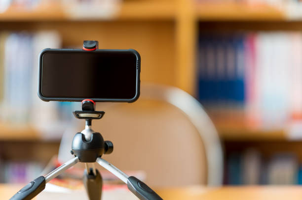 istock A mobile phone mounted on a tripod is used to teach students online at the library. 1278593782