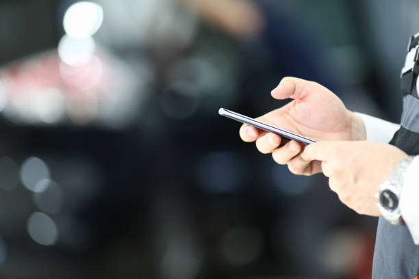 istock Male hands holding mobile phone on blurred background 1278594999