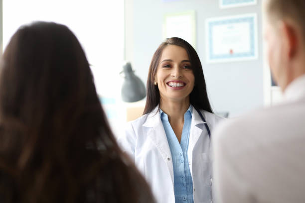 istock Cheerful female doctor talking with colleagues at work 1278595420