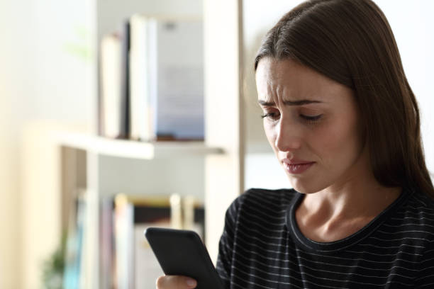 istock Sad woman checking smart phone content at home 1278595497