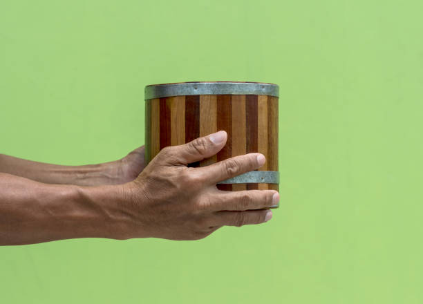istock Ancient wooden bucket carrying hand with green wall. 1278595865