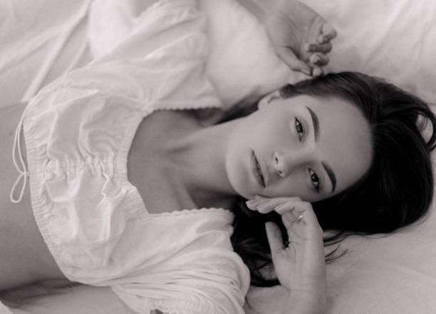 istock Woman lies on a mattress with white bedding. 1278596033