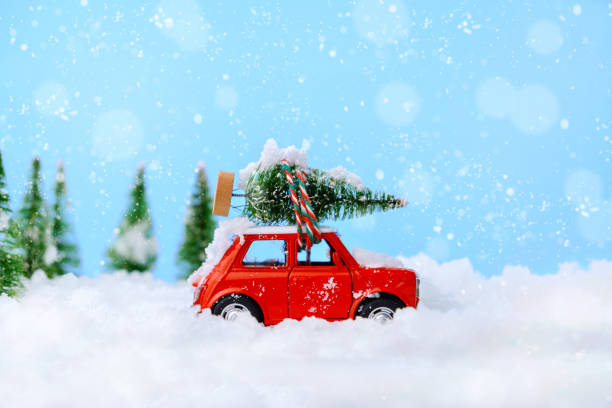 istock Christmas tree on red car toy with blurred tree background and snow. 1278598720