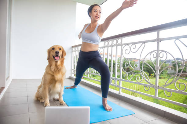 Beautiful Chinese woman practicing warrior pose with her pet