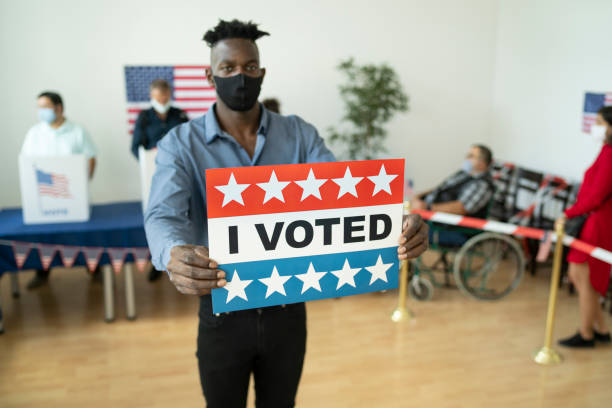 istock Young afro man holding a sign 