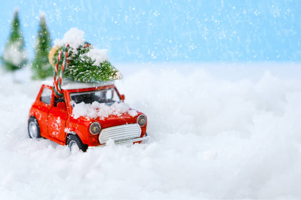 istock Christmas tree on red car toy with blurred tree background and snow. 1278599292