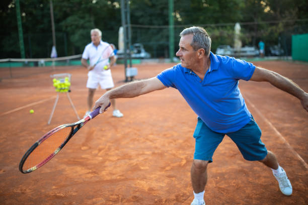 istock Senior man practicing volley technique on tennis court 1278599319