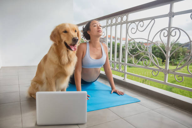 istock East Asian woman practicing upward facing dog with her pet 1278600052