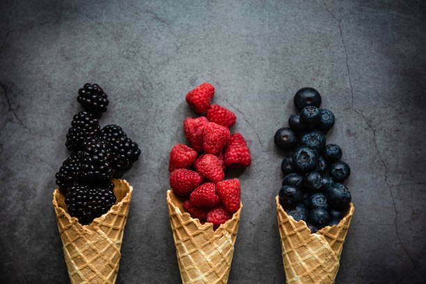 istock Fresh berries in waffle cones on dark stone background 1278601146