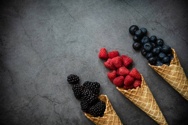 istock Fresh berries in waffle cones on dark stone background 1278601789