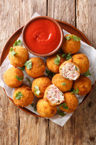 istock Deep fried sauerkraut balls with ham close-up in a plate. vertical top view 1278601845