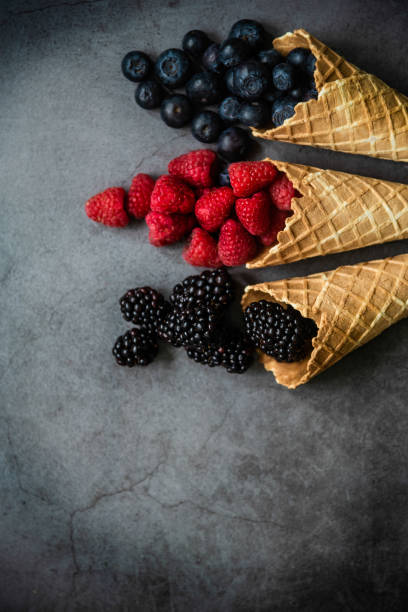 istock Fresh berries in waffle cones on dark stone background 1278601848