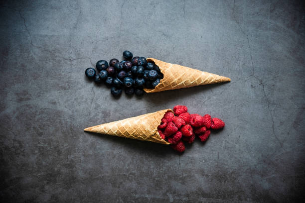 istock Fresh berries in waffle cones on dark stone background 1278601911