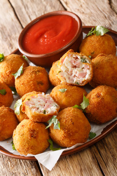 istock Deep fried sauerkraut balls with ham close-up in a plate. vertical 1278602038