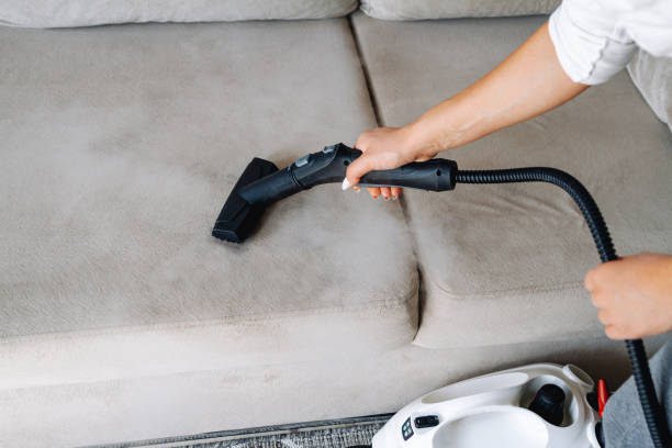 istock Hand cleaning a sofa with steam cleaner, Home cleaning concept. 1278602119