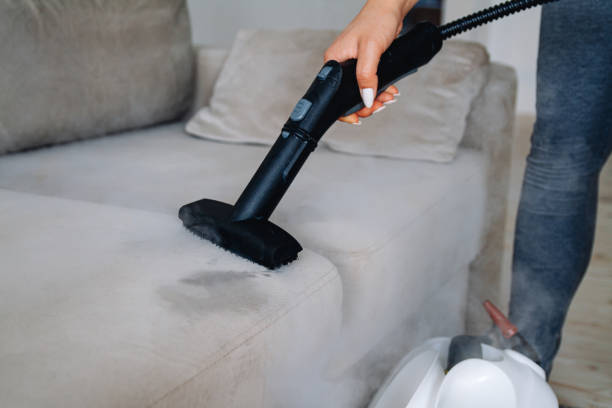 istock Hand cleaning a sofa with steam cleaner, Home cleaning concept. 1278602165