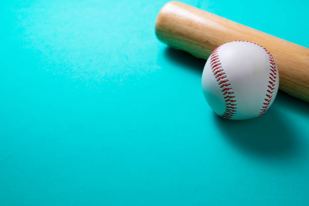 istock baseball and baseball bat on green table background, close up 1278602370