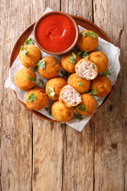 istock Delicious appetizer Sauerkraut balls with ham close-up in a plate. vertical top view 1278602820