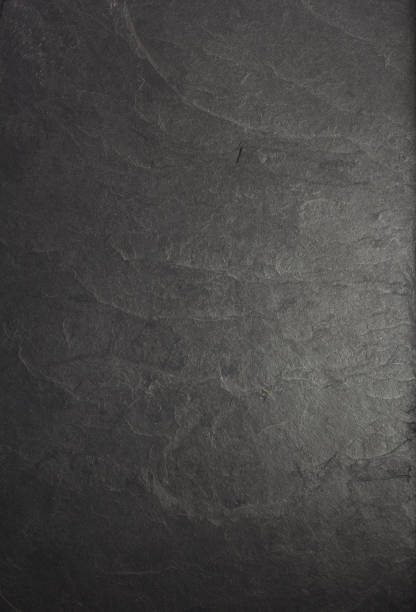 istock black slate stone at wooden background texture 1278603961