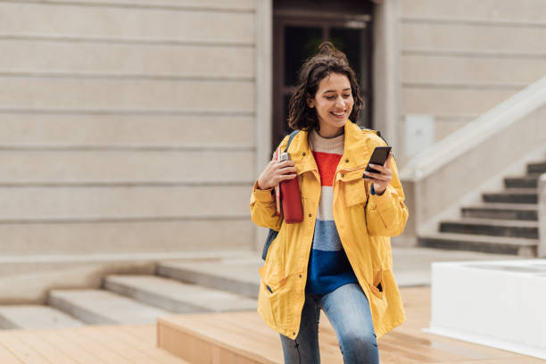 istock Beautiful student standing in front of her college and surfing the net 1278604111