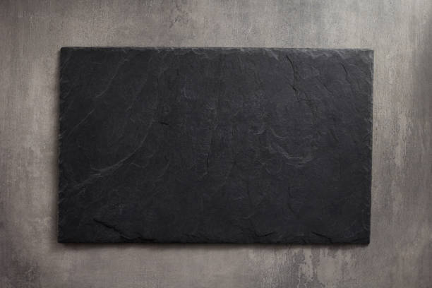 istock black slate stone at wooden background texture 1278604116