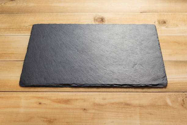 istock black slate stone at wooden background texture 1278604308