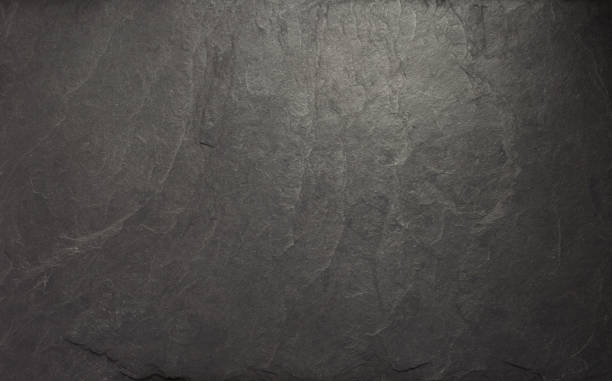 istock black slate stone at wooden background texture 1278604348
