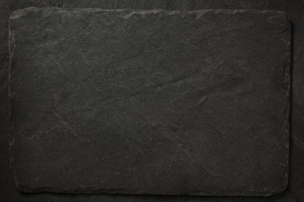 istock black slate stone at wooden background texture 1278604350