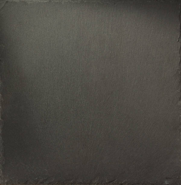 istock black slate stone at wooden background texture 1278604366