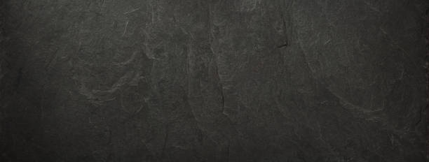 istock black slate stone at wooden background texture 1278604394