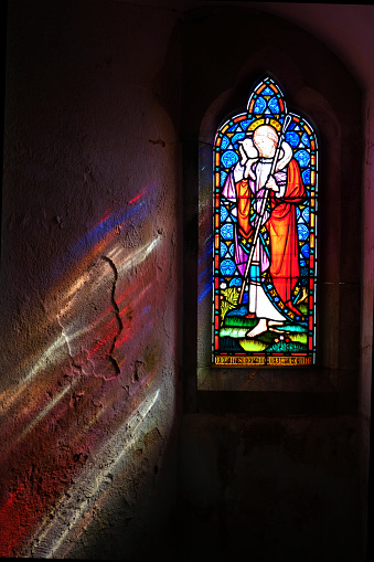 Religious stained glass window, Grade Church, Cornwall, UK.