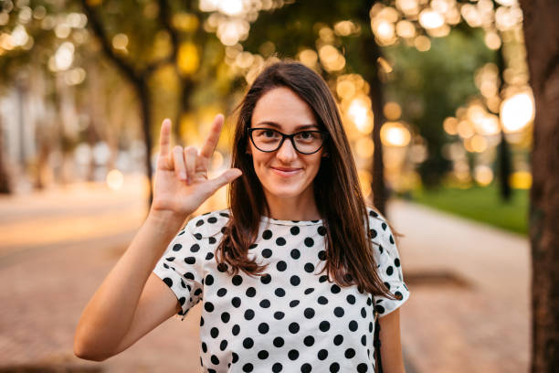 Woman showing "Love" on sign language Beautiful young Deaf and hard hearing woman showing "Love" on sign language. sign language stock pictures, royalty-free photos & images