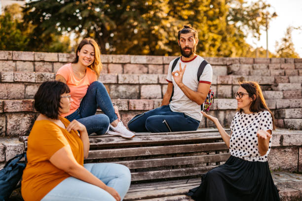 Friends speak in sign language Deaf and hard hearing people speak in sign language outdoors. american sign language photos stock pictures, royalty-free photos & images