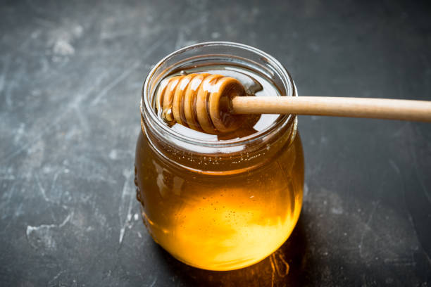 istock Jar with freshly harvested liquid honey on the old wooden table 1278608619
