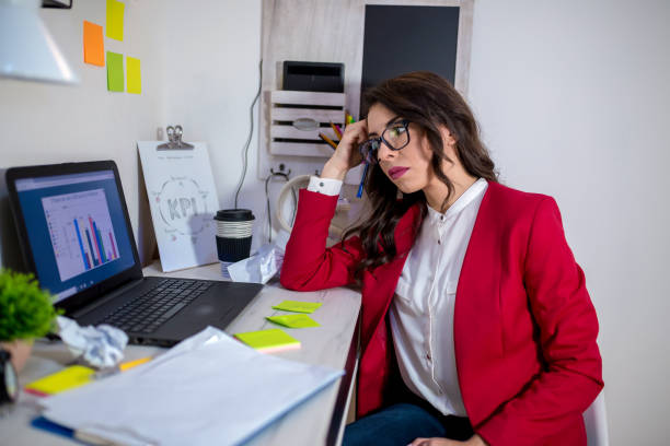 istock Young girl sitting at the table and working with a computer 1278608819