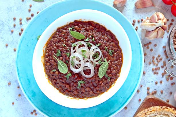 istock Lentils with stewed onion and tomato in a white bowl. 1278608906