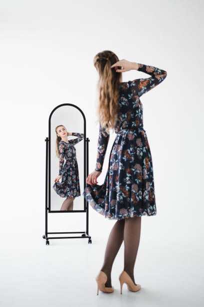 istock Woman model looks in the mirror. 1278609939