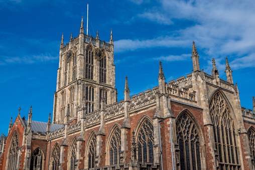 Hull Minster church tower with clock with a blue sky background on a sunny day.