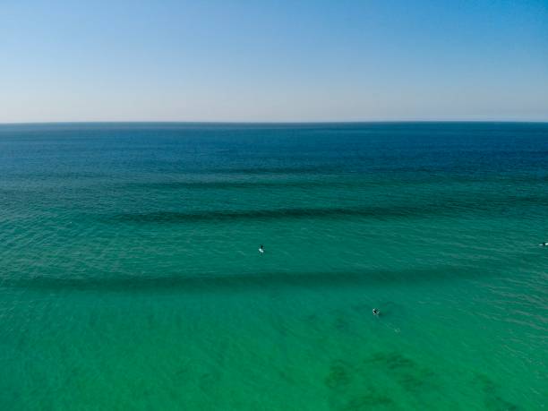 ein paddle boarder im türkisfarbenen wasser am fistral beach, newquay - tide aerial view wave uk stock-fotos und bilder