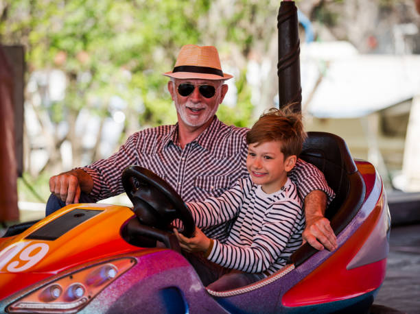 istock Grandfather and grandson hawe fun in bumper car 1278618363