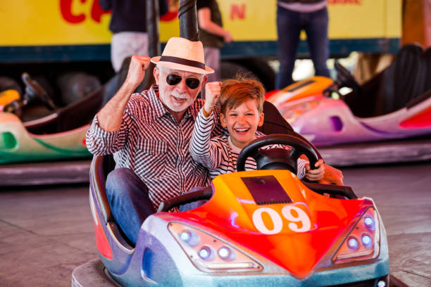 istock Grandfather and grandson hawe fun in bumper car 1278618410
