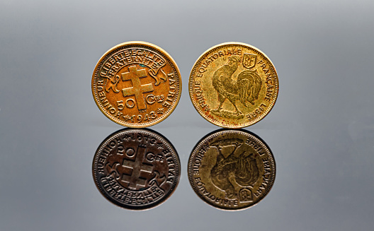 50 Cent 1943 French colonial coinage Afrique equatoriale francaise with two sides on a reflective surface. 1942-1943 years