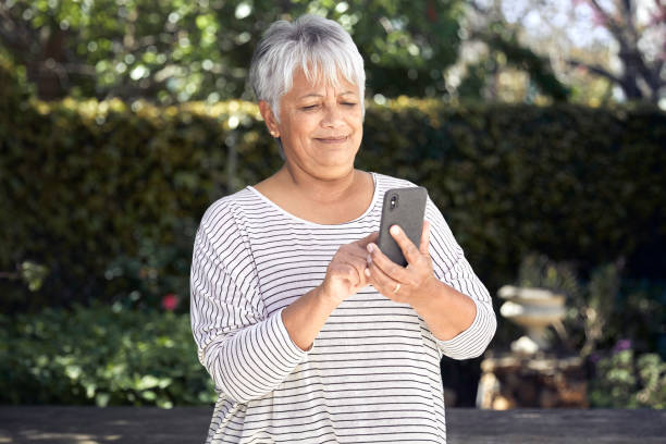 istock Not so impressed senior woman using cellphone 1278618698