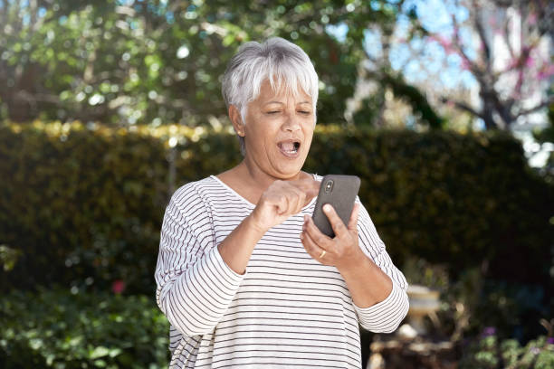 istock Chocked senior woman using cellphone 1278618700