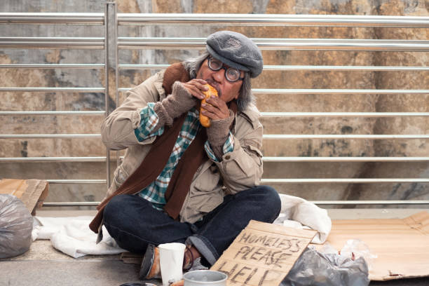 istock Aged homeless begger eating bread on the bridge 1278625036