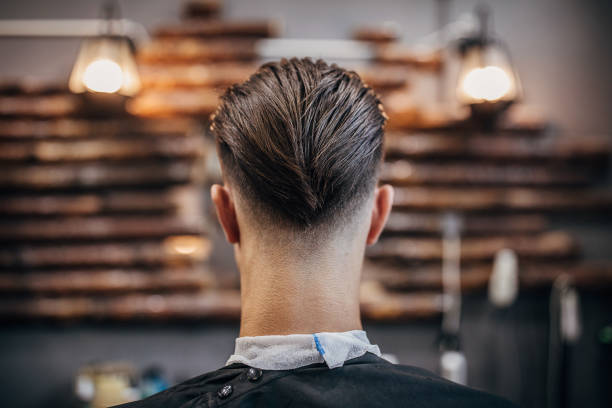Handsome man with modern haircut One man, handsome young man with modern haircut at the barber shop. men hair cut stock pictures, royalty-free photos & images