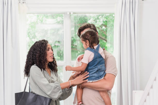 istock Mother, home from work, reaches for daughter 1278631624