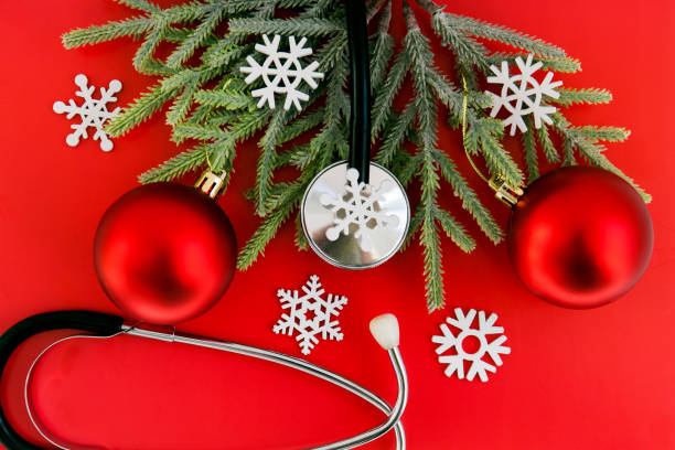 istock Stethoscope surrounded by red christmas tree balls on red background 1278634345