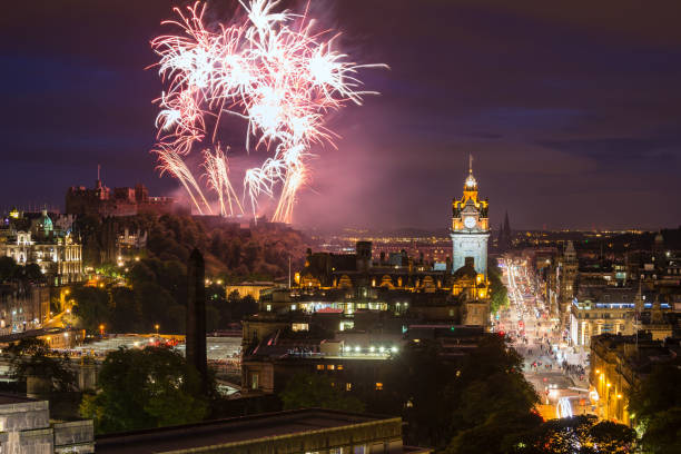 Edinburgh Cityscape with fireworks over The Castle and Balmoral Clock Tower Edinburgh Cityscape with fireworks over The Castle and Balmoral Clock Tower hogmanay photos stock pictures, royalty-free photos & images